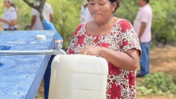 Cinco comunidades indígenas de Maicao se ven beneficiadas con los microacueductos. Aquí observamos a una mujer wayuu recorriendo agua y se le ve muy feliz.