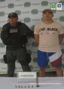 En la imagen se ve una persona detenida, junto con un uniformado de la Policía.