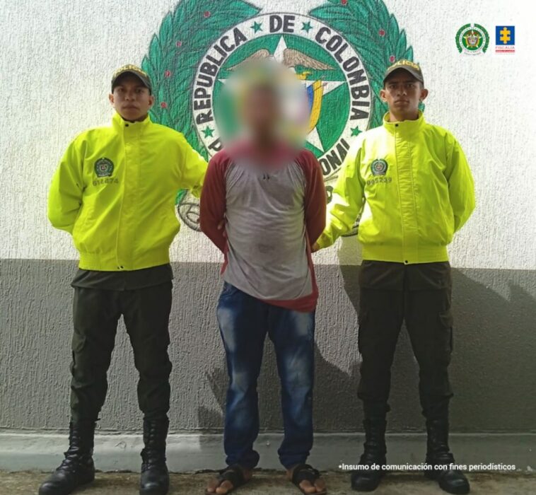 En la imagen se ve a una persona detenida entre dos funcionarios de la Policía Nacional.