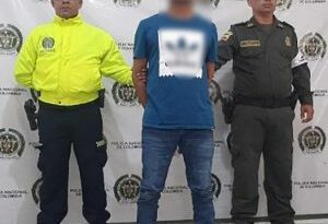 Dos uniformados de la Policía Nacional custodian al procesado (de camisa azul).