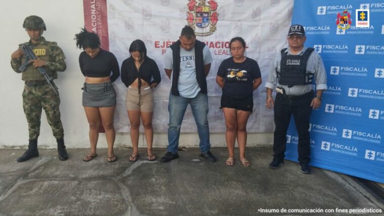 capturados de frente esposados manos atrás, custodiados por investigador del CTI de la Fiscalía y militar del Ejército Nacional.