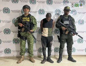 En la fotografía aparece el capturado junto a un agente del Gaula de la Policía y un soldado del Gaula Militar. En la parte superior está un banner de la Policía Nacional.