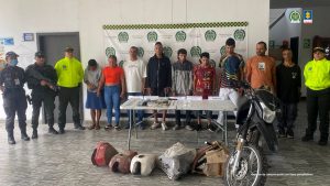 En la fotografía se aprecian de pie y en hilera a los presuntos integrantes de ‘Los Chigüiros’. A los extremos de ellos hay uniformados de la Policía Nacional. Delante de ellos hay una mesa y sobre ella hay dinero en efectivo, teléfonos celulares, gran cantidad de bolsas plásticas con contenido de color blanco, beage y rosado; así como otros elementos. En el suelo se aprecian partes de motocicletas y al lado una motocicleta. En la parte posterior hay un pendón de la Policía.