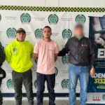 En la fotografía aparece el capturado junto a un funcionario del CTI y tres uniformados de la Policía Nacional. En la parte superior está un banner de la Policía Nacional.