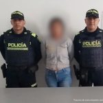 En la fotografía se ve a la presunta agresora acompañada por dos uniformados de la Policía Nacional.