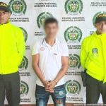 Los dos hombres aparecen en fotografías independientes, con sus manos esposadas y custodiados por uniformados de la Policía.