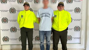 En la imagen se puede ver a un hombre detenido bajo custodia de efectivos de la Policía Nacional.